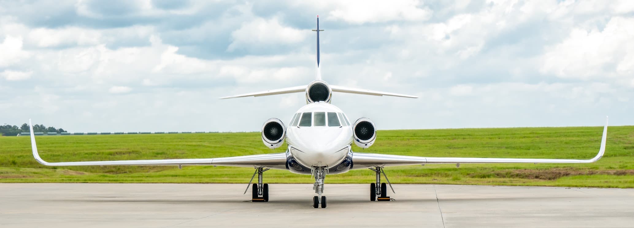 Stand-up cabin interior featuring executive club seating and foldout tables in a Dassault Falcon 50EX