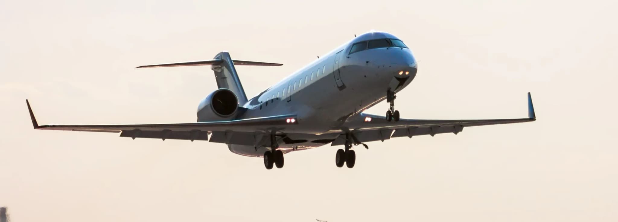 Bombardier Challenger 850 private jet parked on the airport apron showcasing its spacious heavy-jet cabin for luxury charter flights