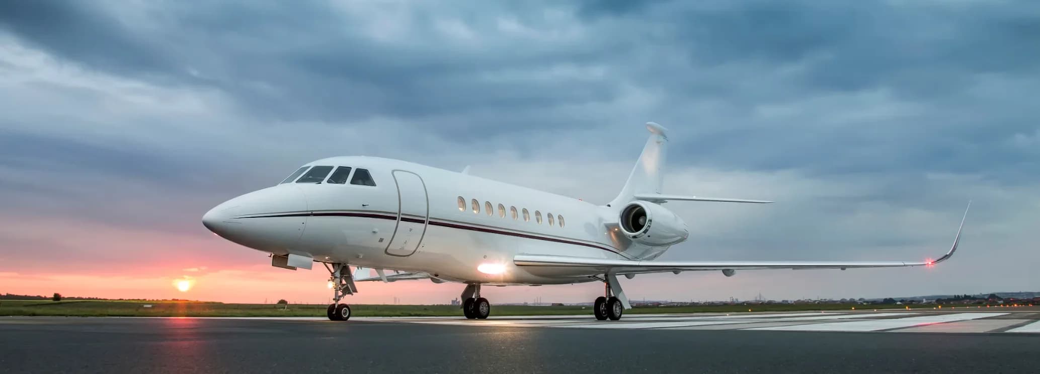 Dassault Falcon 2000EX EASy super midsize jet parked on the tarmac ready for charter flight booked through the official Hogani Jets website