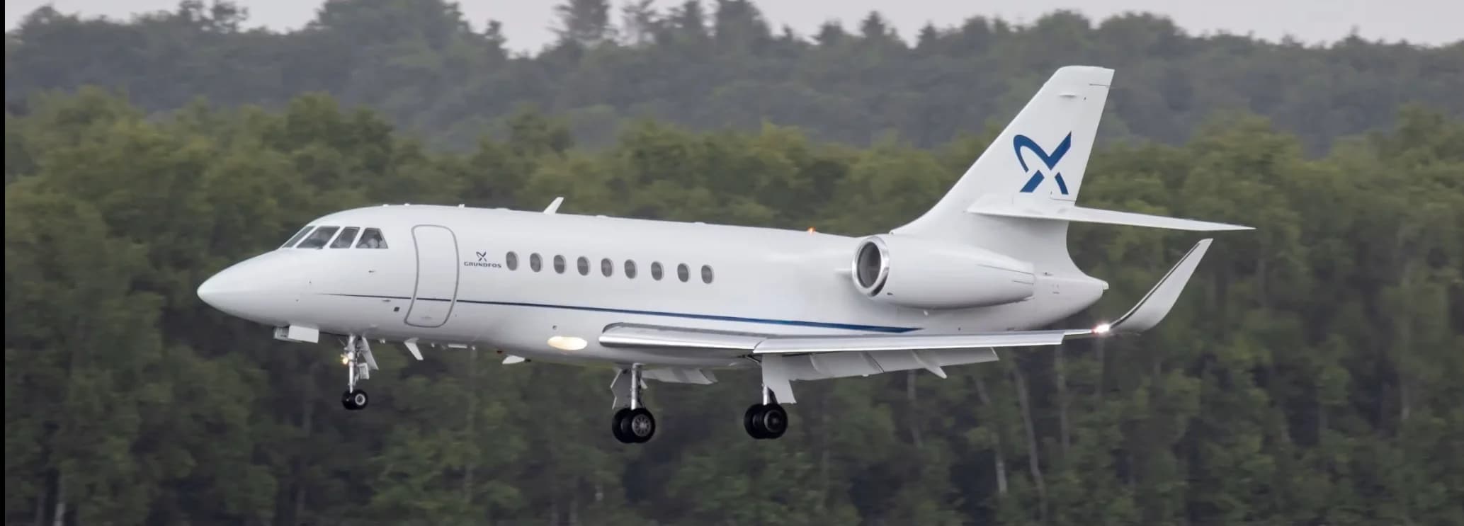 Dassault Falcon 2000LX super midsize private jet with winglets parked on the tarmac