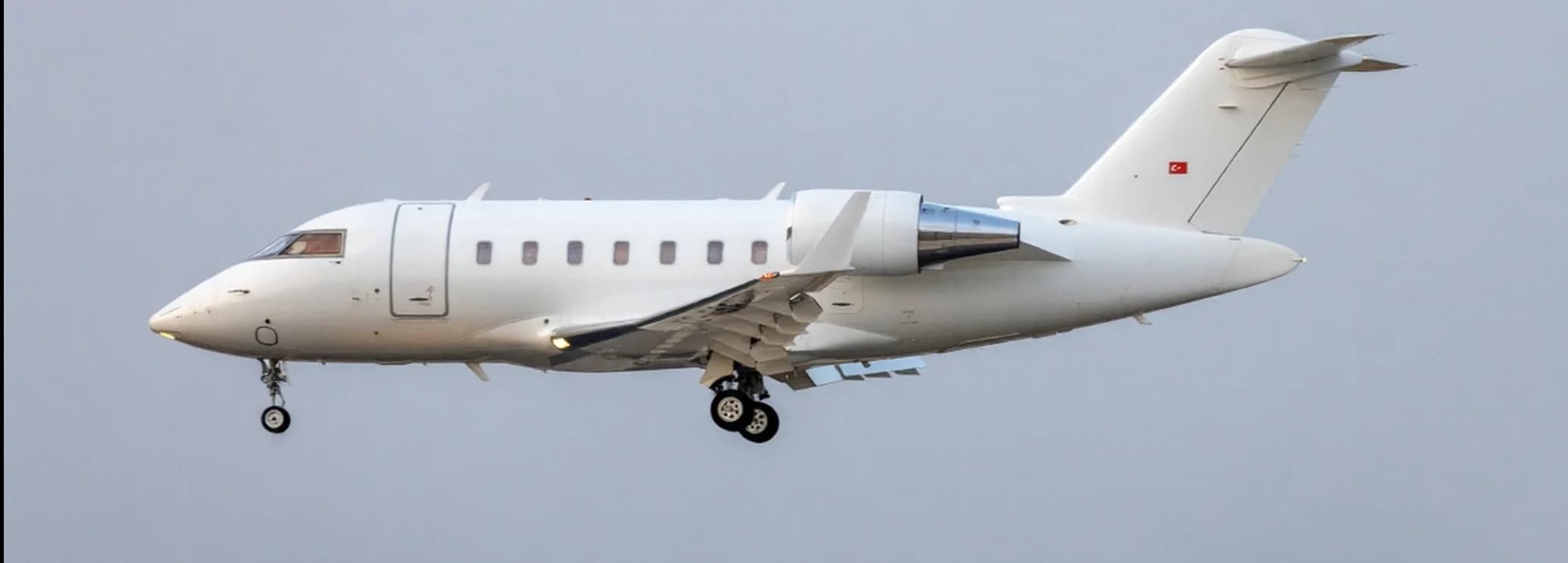 Wide stand-up cabin interior showing executive club seating layout in a Bombardier Challenger 600