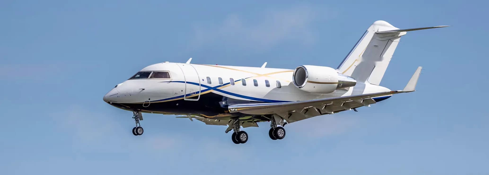 Redesigned wide-body interior cabin showing executive seating and divan in a Bombardier Challenger 650
