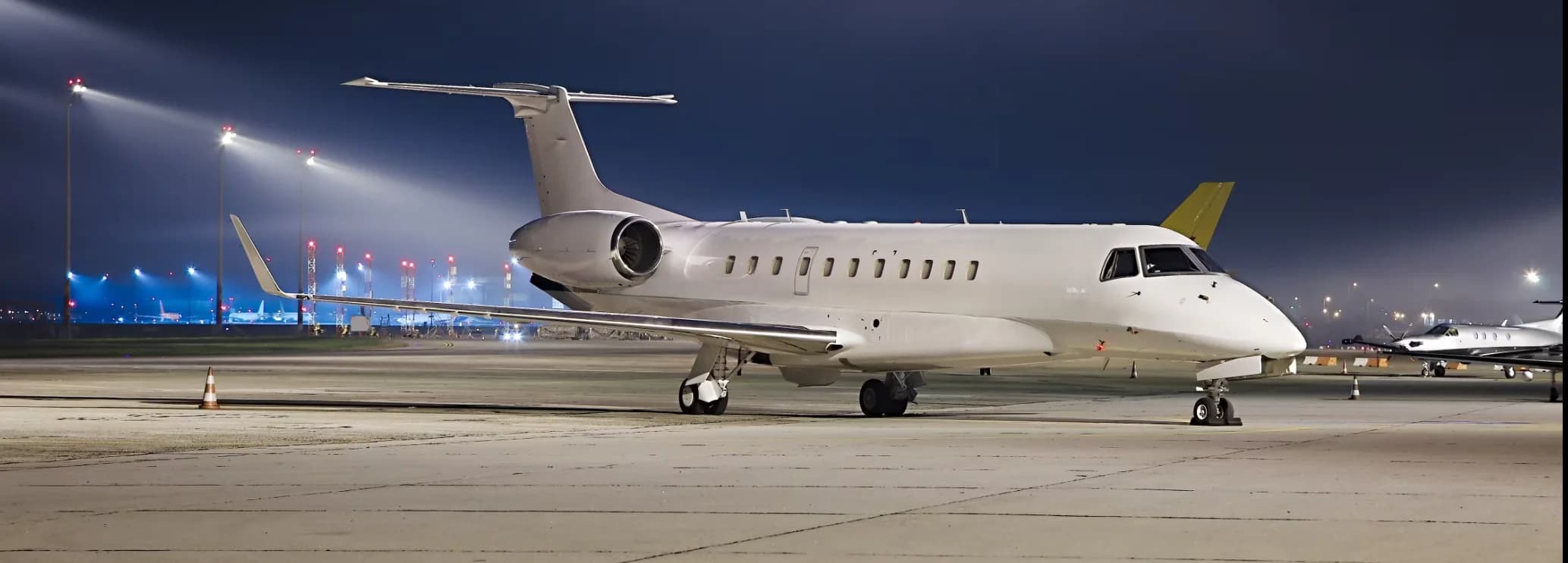 Embraer Legacy 600 heavy private jet parked on the airport tarmac ready for a charter flight