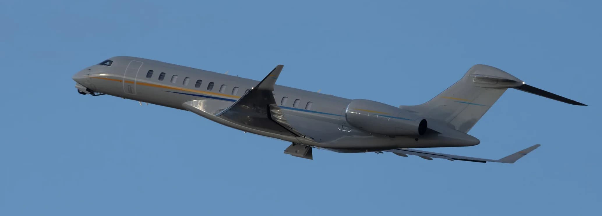 Exterior side profile of a Bombardier Global 7500 private jet parked on the airport tarmac.