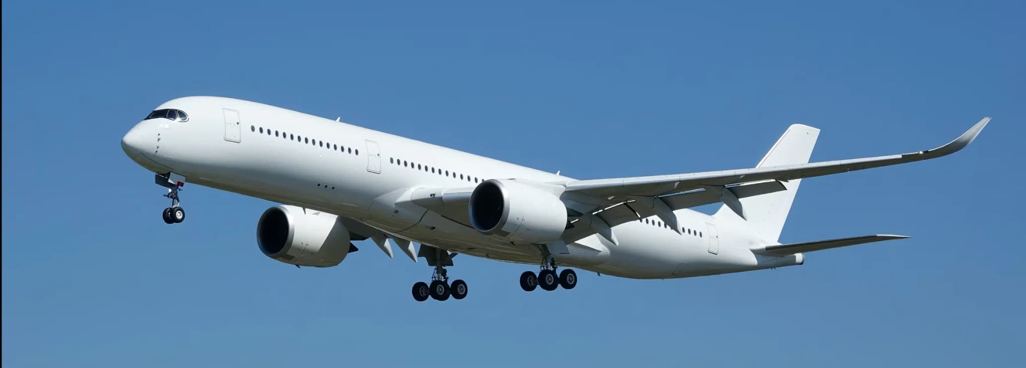Airbus ACJ350 XWB private jet exterior on tarmac displaying twin Rolls-Royce Trent XWB engines and 18.5-foot extra wide body VIP cabin