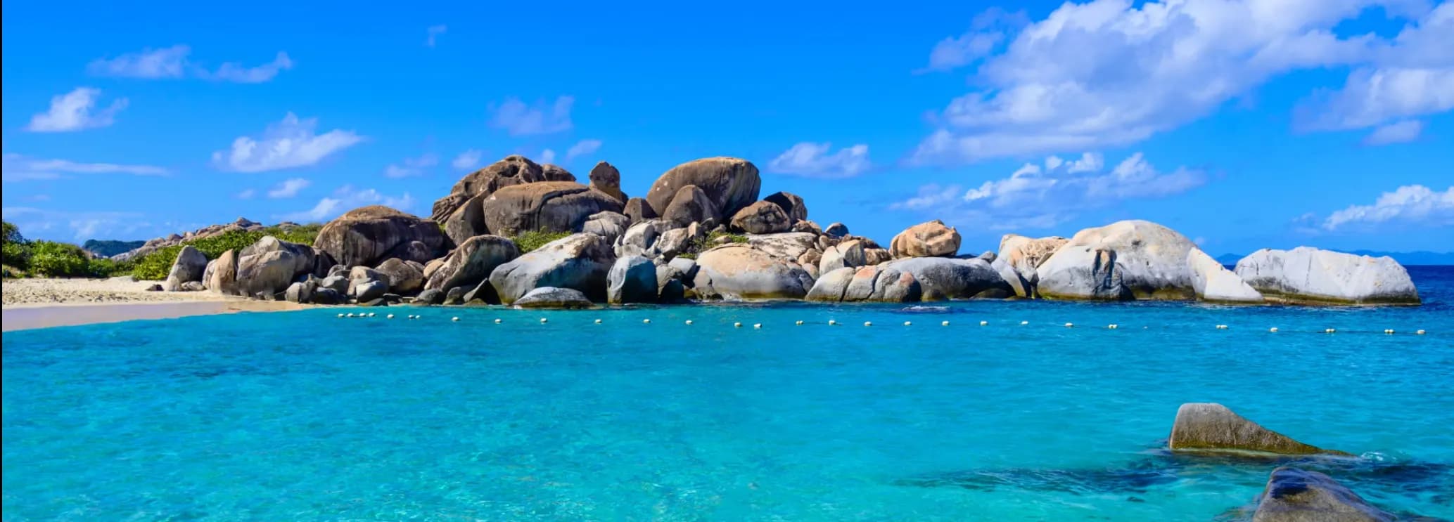 Private charter to Virgin Gorda, BVI, with access via small turboprop, jet gateway, or sea transfer to luxury resorts and The Baths.