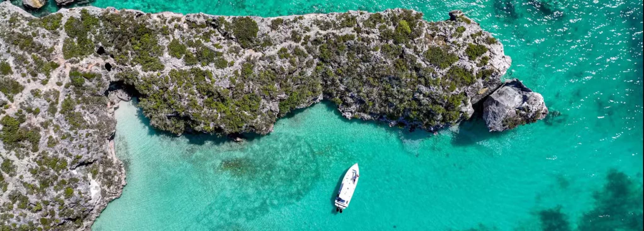 Private jet charter to Providenciales, Turks and Caicos, arriving at PLS Airport near Grace Bay Beach, Amanyara, and luxury resort areas.