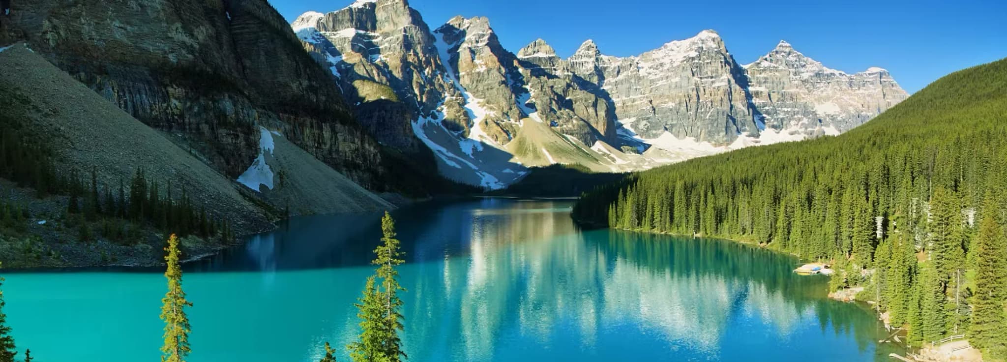 Vivid turquoise waters of Moraine Lake framed by the snow-capped Valley of the Ten Peaks in Banff National Park.