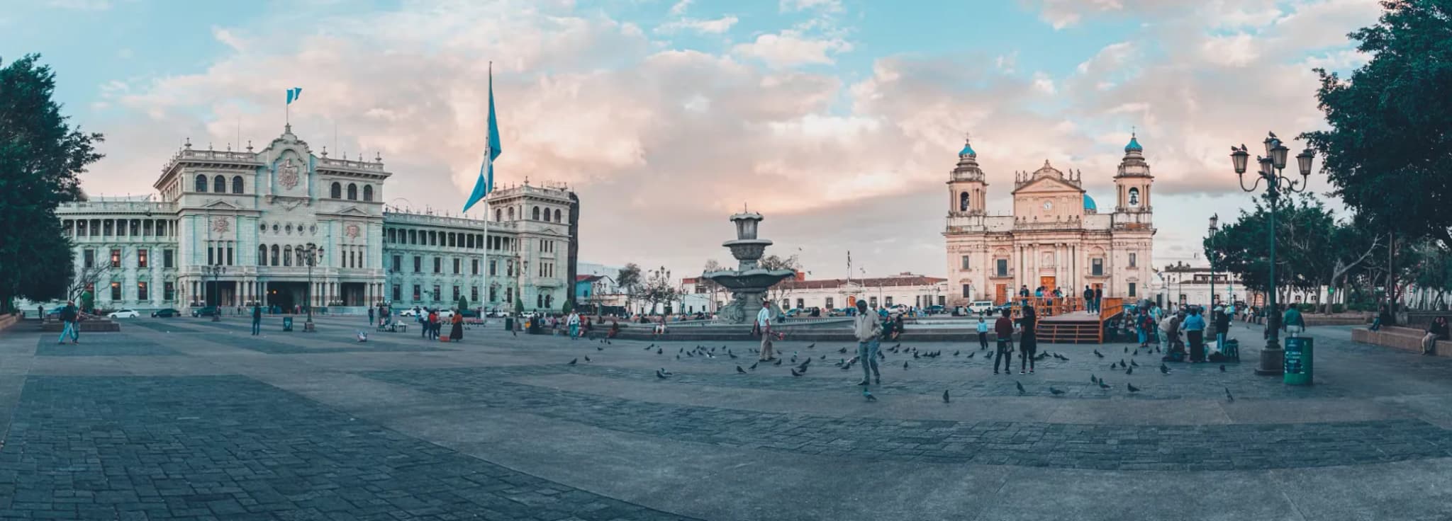 Panoramic view of Plaza de la Constitución showing the National Palace of Culture and Metropolitan Cathedral in Guatemala City.