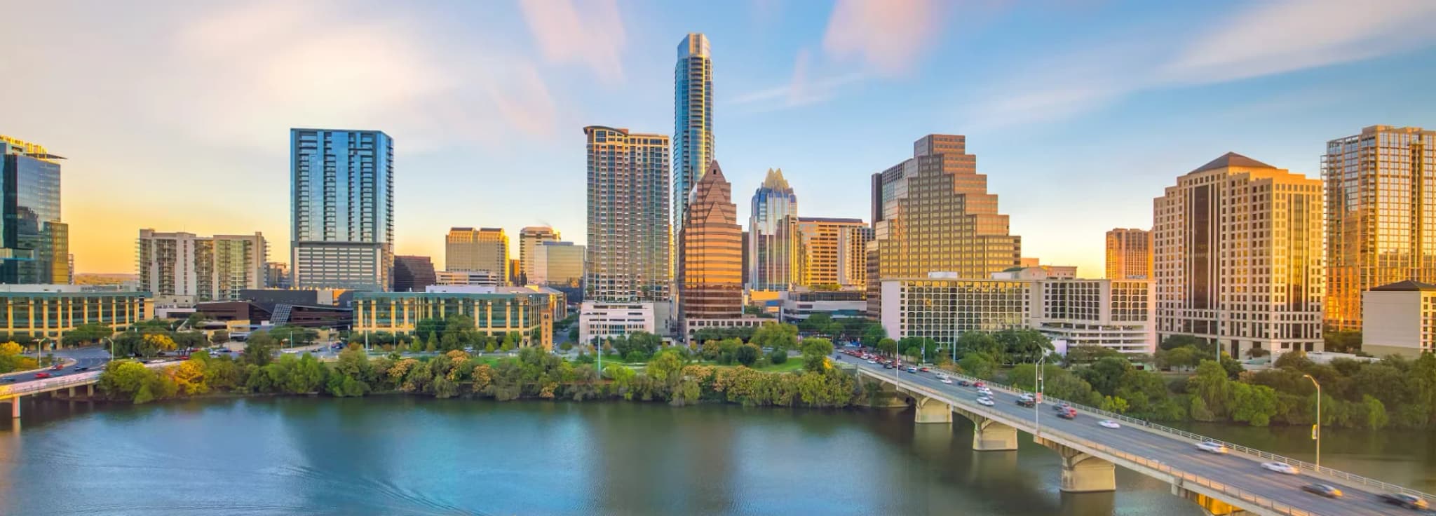 Downtown Austin Texas skyline reflected over Lady Bird Lake at sunset.