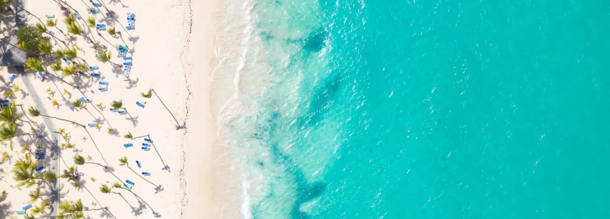 Private jet charter to the Caribbean, with a jet over turquoise water and white-sand islands