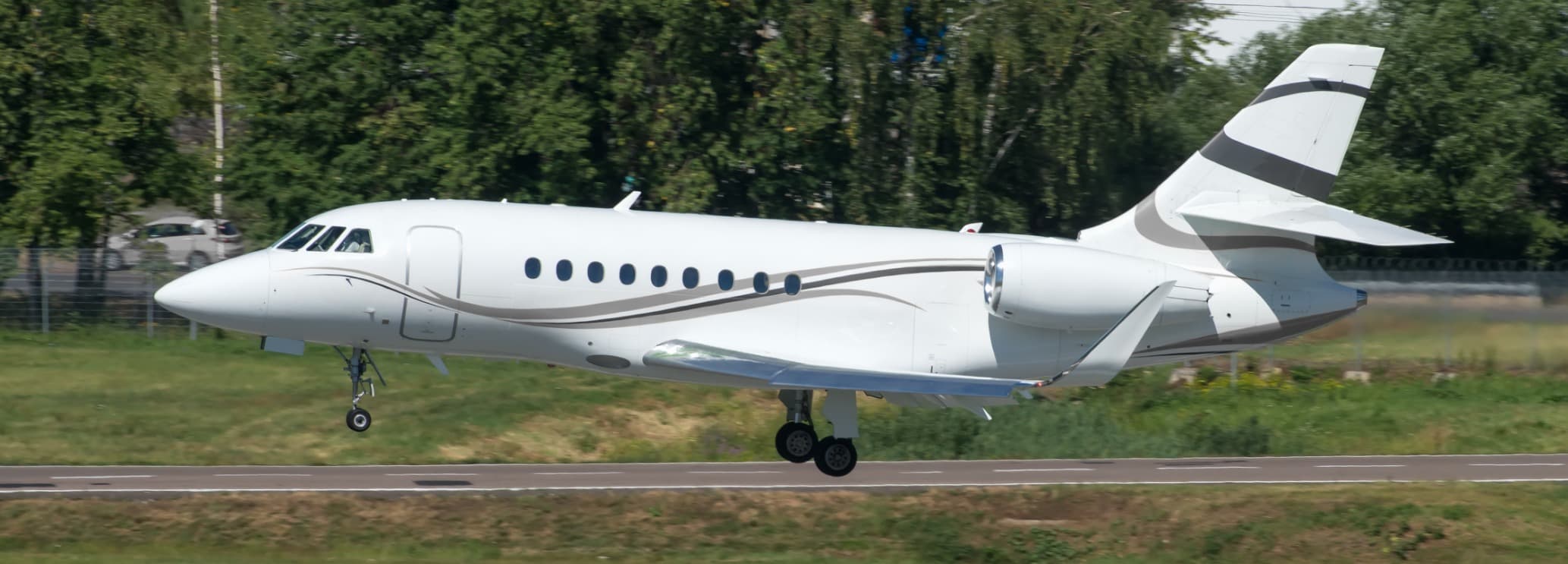 Spacious stand-up cabin interior showing double club executive seating in a Dassault Falcon 2000EX