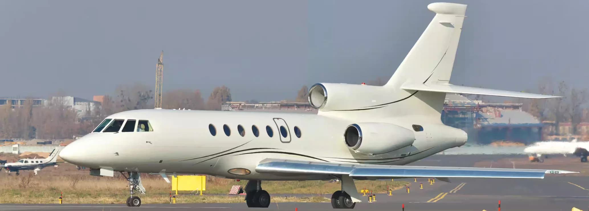 Dassault Falcon 50 private jet in flight, showcasing its trijet design and intercontinental charter capability
