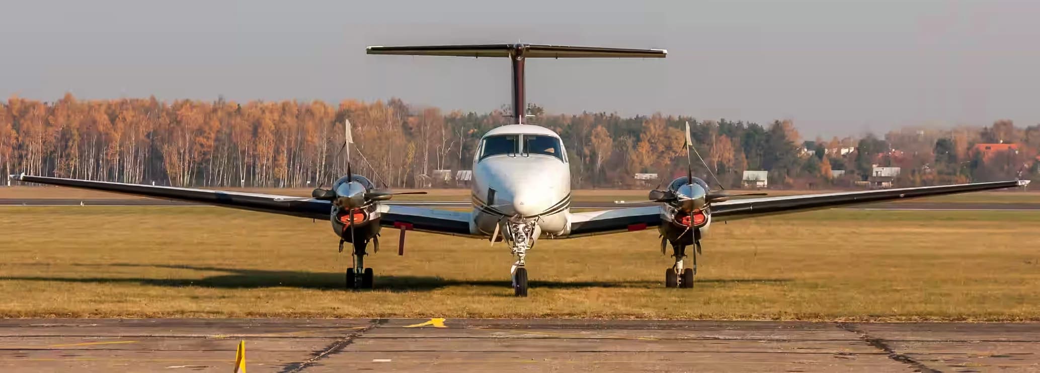 Spacious club-style cabin interior of a Beechcraft King Air 100 configured for executive travel.