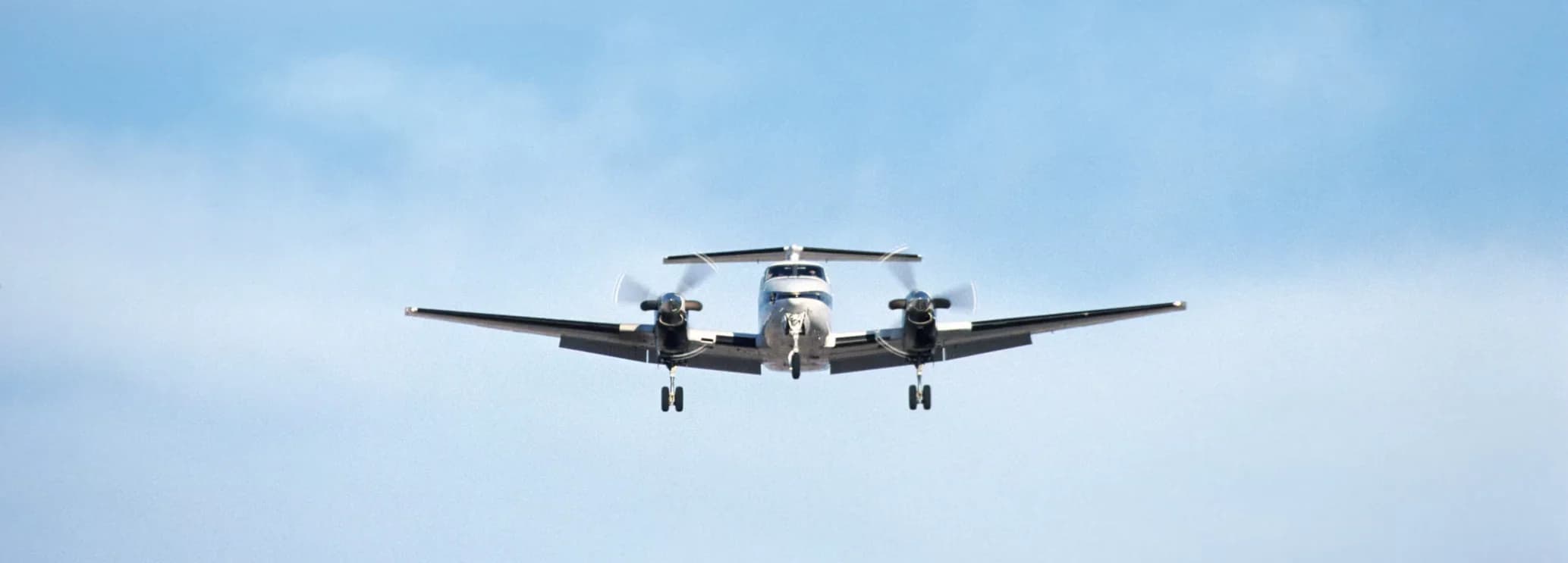 King Air 300 twin-engine turboprop aircraft parked on an airport apron before departure.