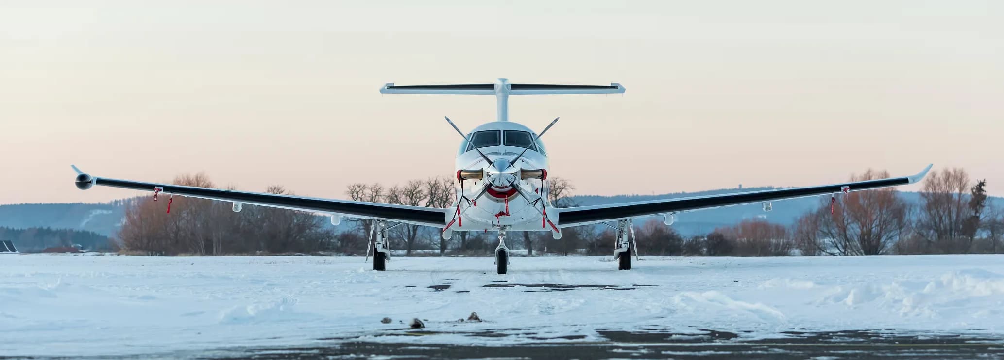 Pilatus PC-12 NGX turboprop charter aircraft ready for departure at a private airport.