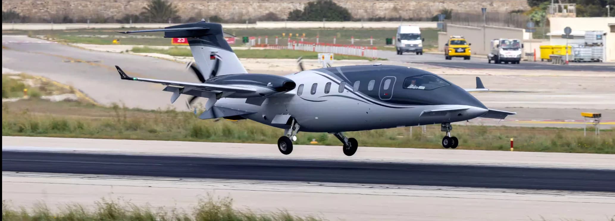 Piaggio Avanti EVO twin-engine turboprop on the tarmac, showcasing its distinctive pusher-prop design, five-blade scimitar propellers, and spacious stand-up cabin.