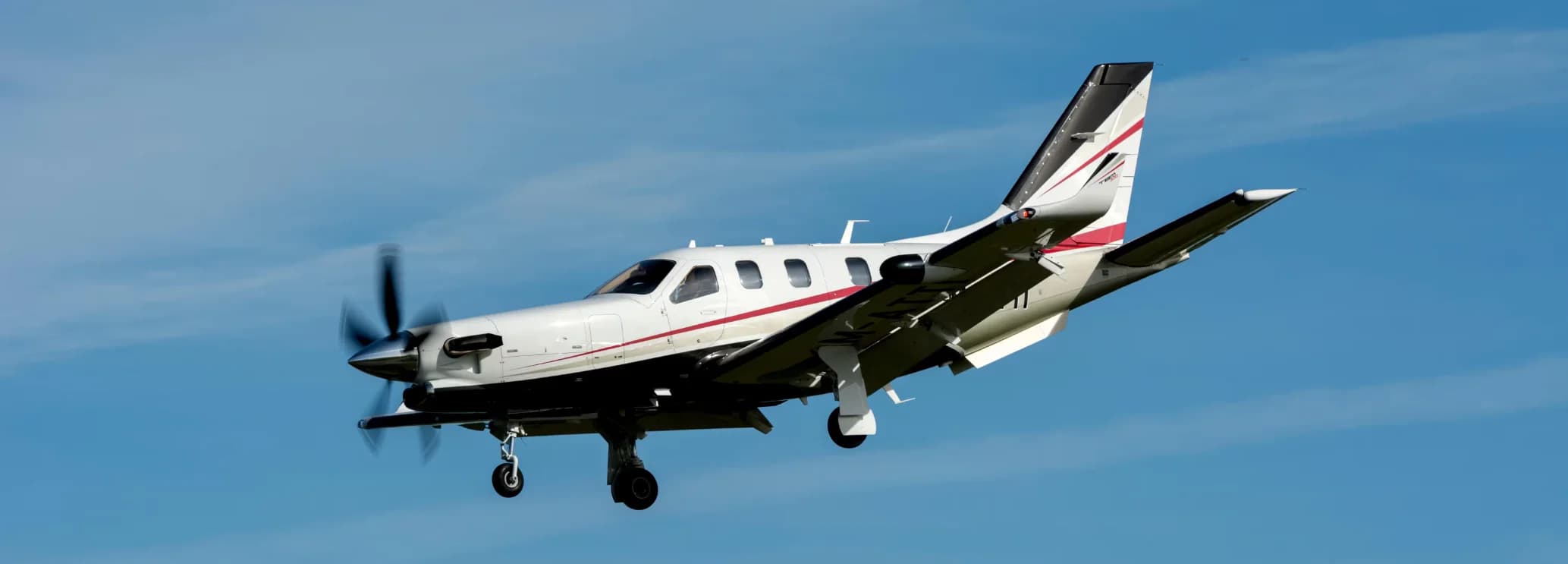 Socata TBM 700 single-engine turboprop parked on the tarmac, showcasing its sleek design and fast regional charter capabilities.