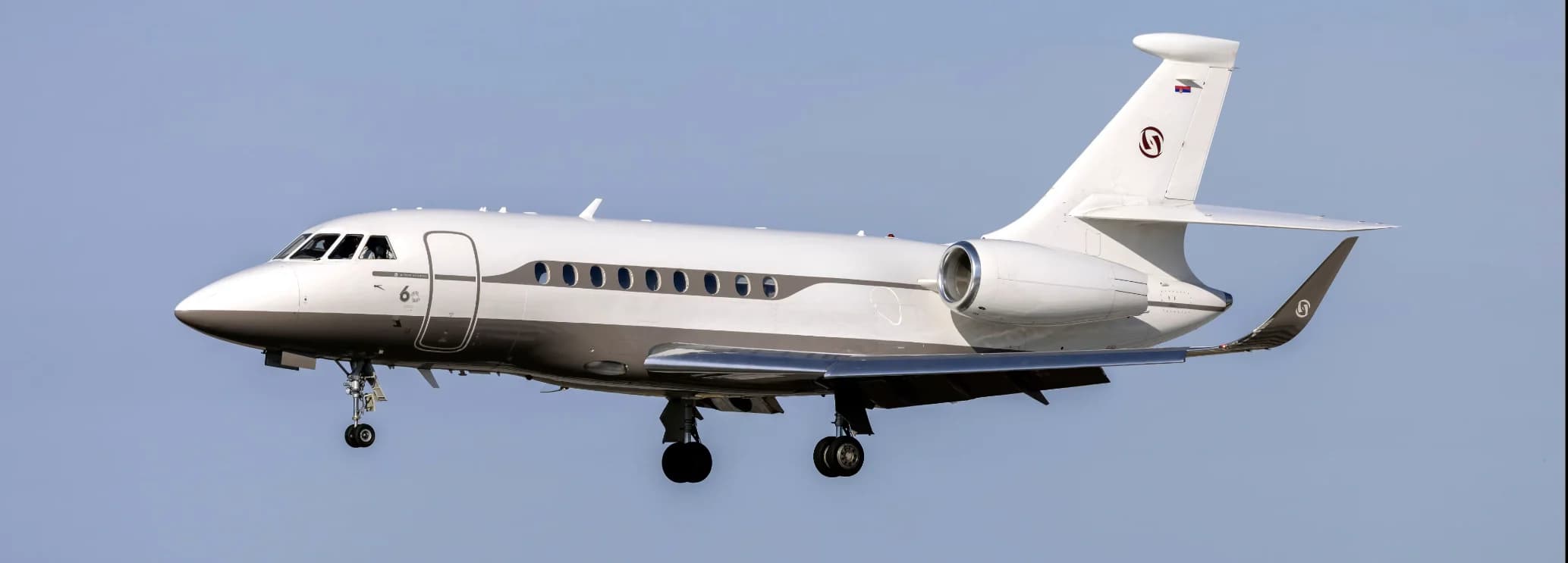 Spacious wide stand-up cabin interior with executive seating in a Dassault Falcon 2000LXS