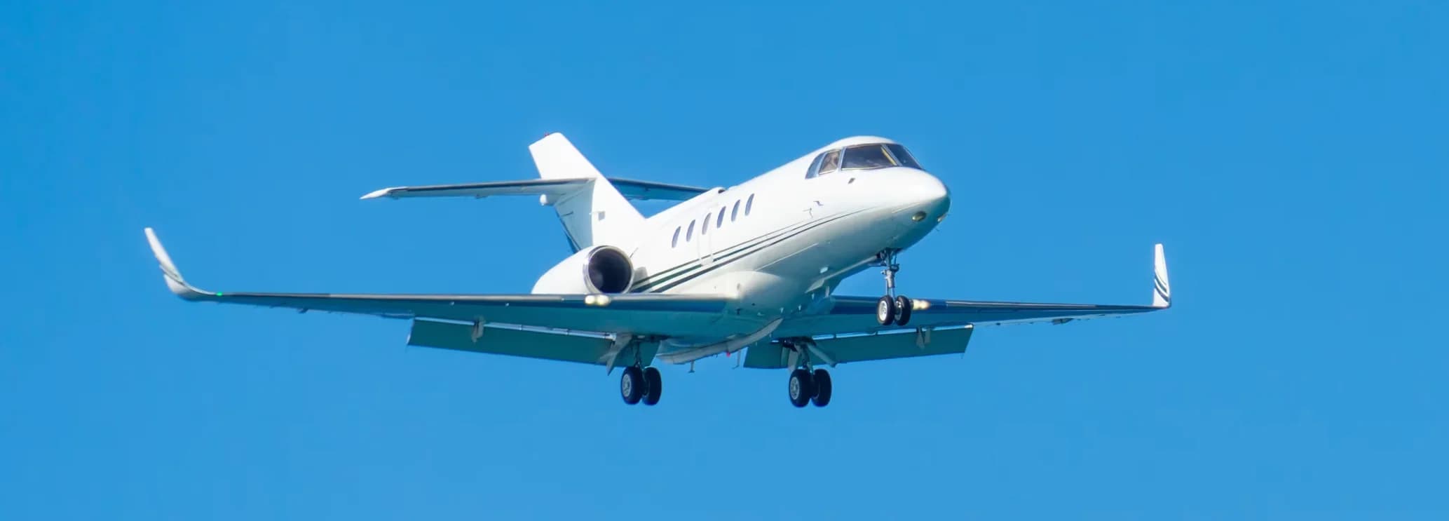 Hawker 1000 super midsize private jet parked on the airport tarmac ready for a charter flight