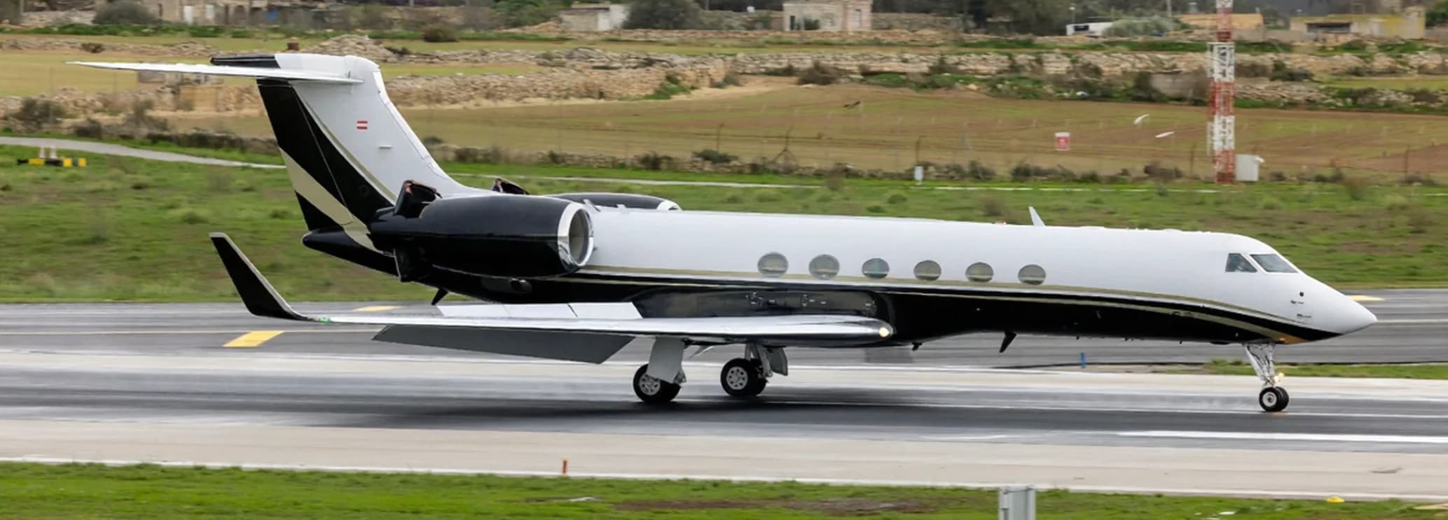 Gulfstream GV executive jet cabin with conference seating, dining area, and long-range amenities