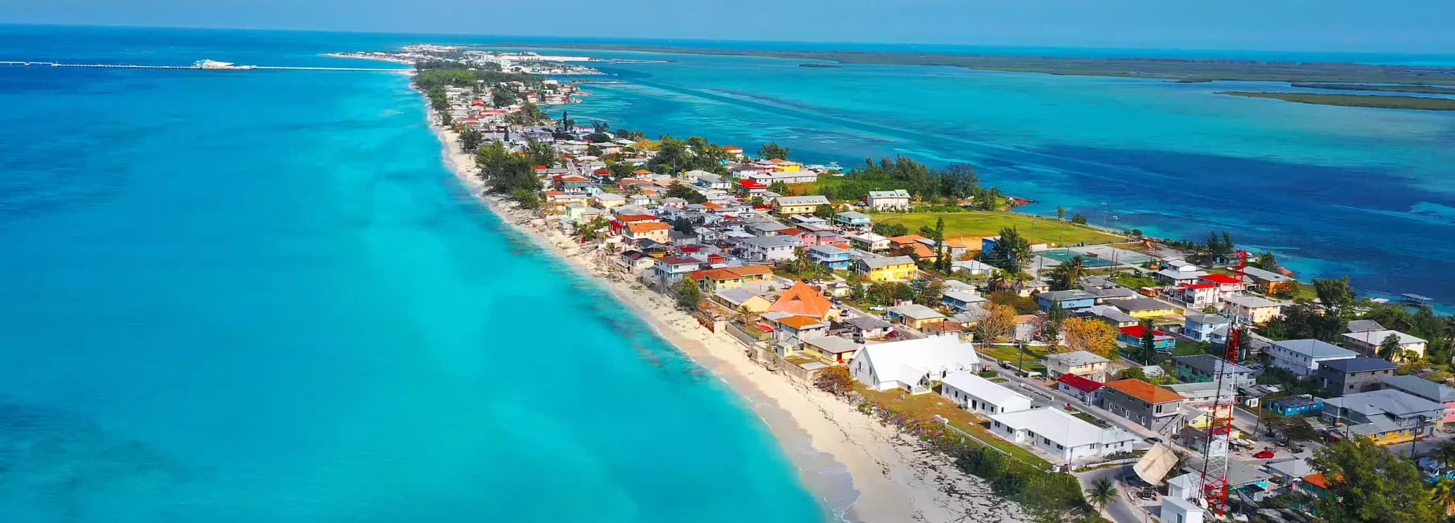 Luxury private jet flying over the turquoise waters of Bimini on a short charter flight from South Florida